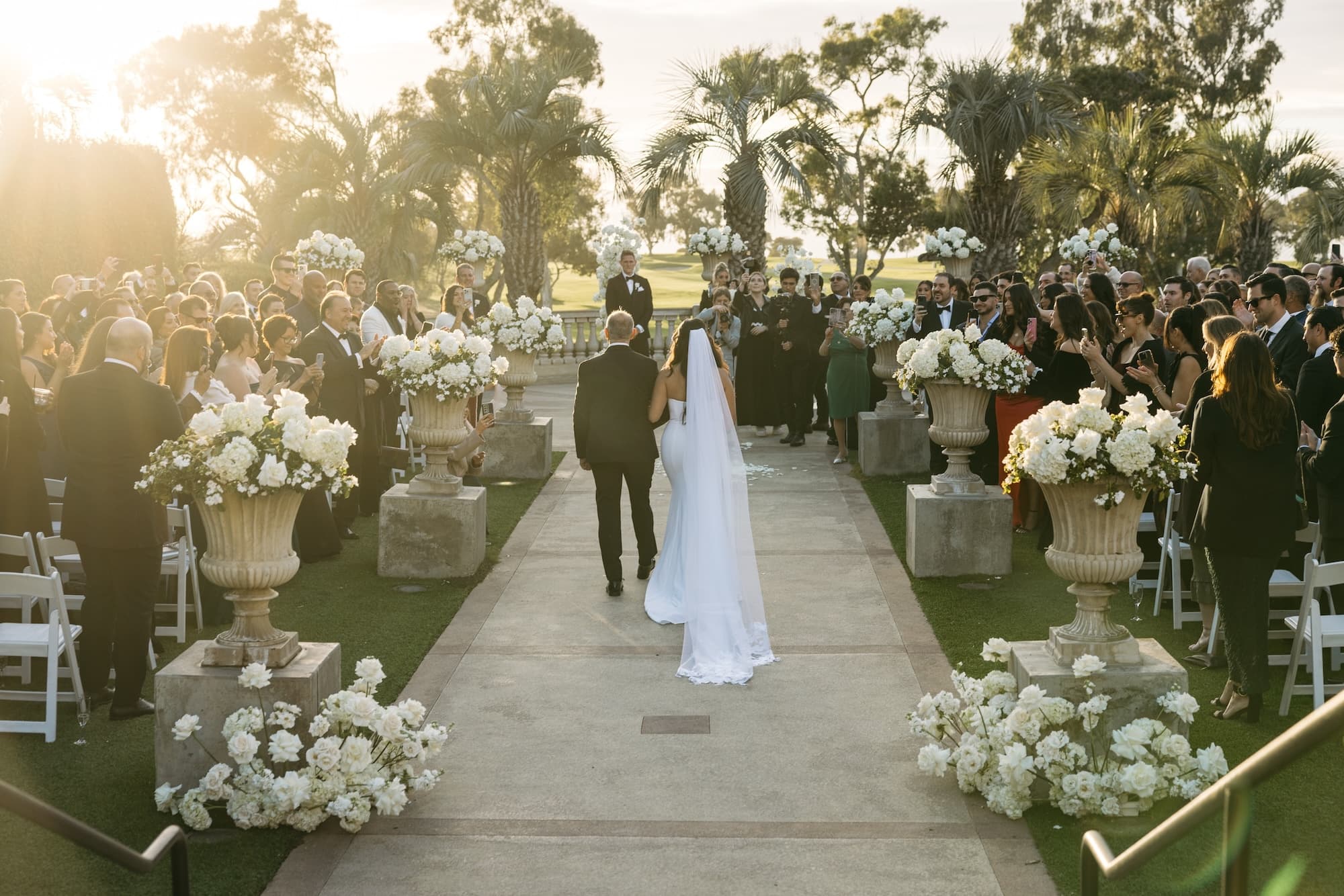 bride and groom getting married in san diego with beautiful flowers